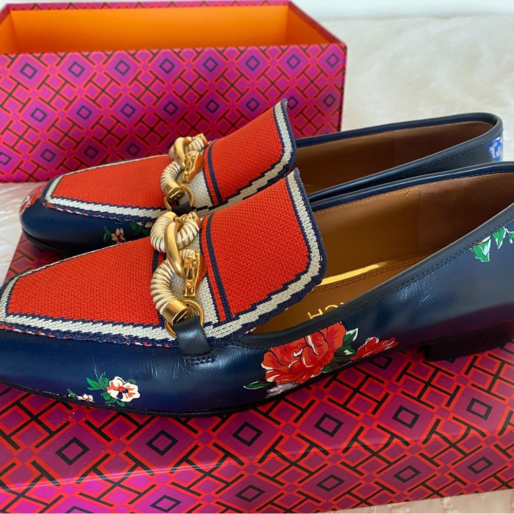Stylish new Tory Burch shoes with a gold statement piece on them.
